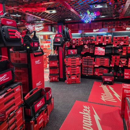 Milwaukee Power ToolsA store aisle filled with vibrant red Milwaukee toolboxes and bags neatly displayed. The bright lights and organized layout create an energetic atmosphere.
